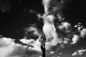 portrait of a girl on the cloudy sky background