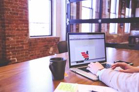 man at the laptop at the table in the office