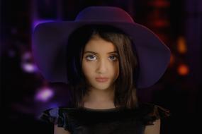 Portrait of the beautiful, young girl in the hat, at background with the colorful bokeh lights, clipart