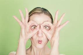 funny Woman making glasses gesture