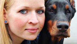 portrait of woman with doberman pinscher