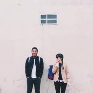 Happy Laughing young Couple at pink wall