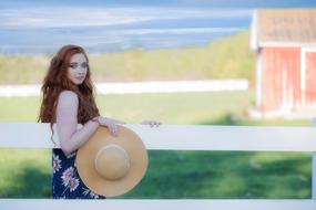 girl with summer hat in hand