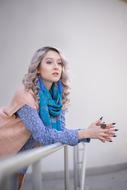 Thoughtful young Woman leaning on railing