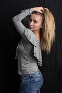 photo of a posing girl with long hair in a photo studio