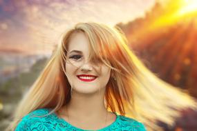 happy blonde girl illuminated by sun