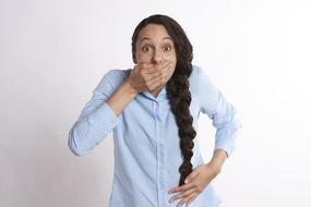 girl with a pigtail covered her mouth with her hand