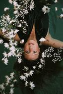 Woman floating in the beautiful, white flowers