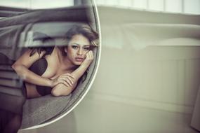 sad beautiful brunette posing lying down