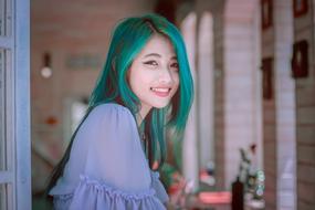 smiling asian girl with green hair