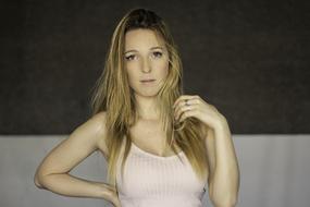 Portrait of the, posing, blonde woman in pink clothing