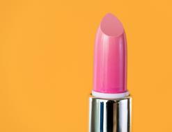 photo of pink lipstick on an orange background