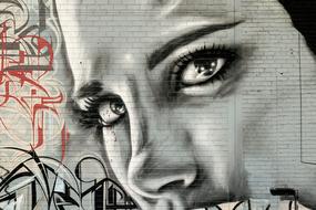 graffiti in the form of a woman's face on the wall