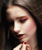 photo of a brunette with red makeup