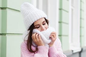 Woman in a winter white scarf and scarf