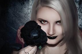 portrait of Woman with black flower at dark lips