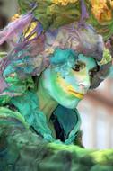 man with paint on his face at the festival