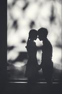 silhouette of a couple in love in a blurred black and white background