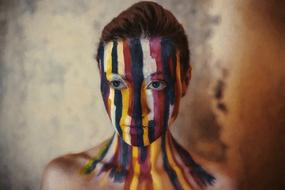 portrait of Woman with colorful stripes of Paint on face and neck