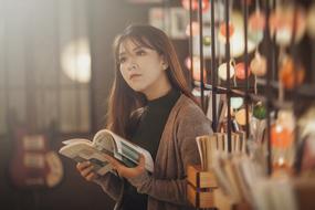 young asian girl with book indoor