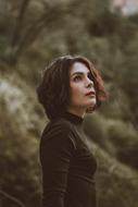 thoughtful woman in forest