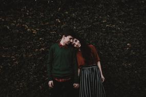 picture of couple among autumnal leaves in a park