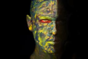 camouflage painted male face at darkness, digital art
