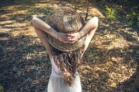 photo of a girl in a straw hat in the countryside
