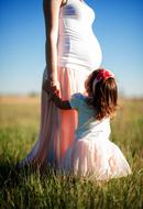 Mother, Pregnant woman with child daughter outdoor