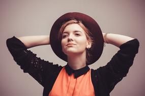 portrait of a girl in a hat in the studio