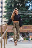 long hair girl in stylish clothe walks in city