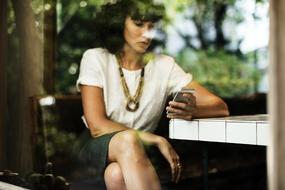 adult woman looking at screen of mobile phone