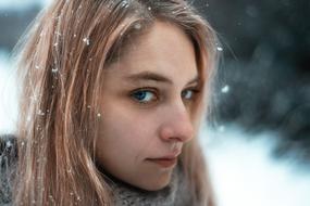 young blonde Woman on snowy weather, portrait
