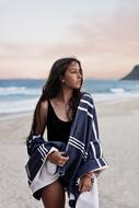 tanned young Woman with towel posing on beach