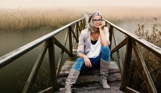 girl on a wooden bridge over the river