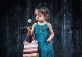 little girl with fluffy dandelion