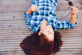 young woman lying on the wooden floor
