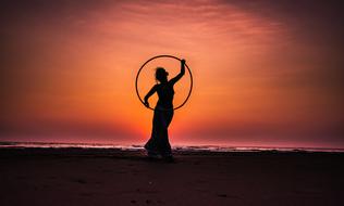 silhouette of lady with Hula Hoop