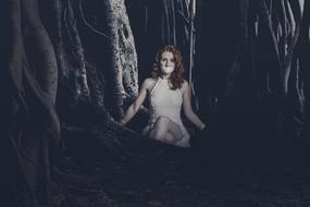 young sexy Woman with cloth on mouth sits in dark Forest, collage