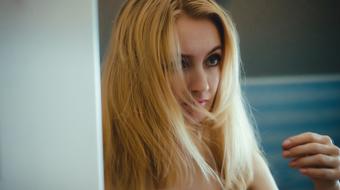 Reflection of blonde long haired girl on Mirror