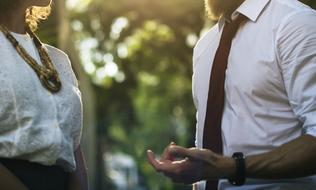 Bearded man communicating with woman outdoor