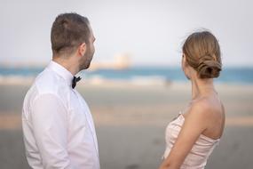 newlyweds look at the sea