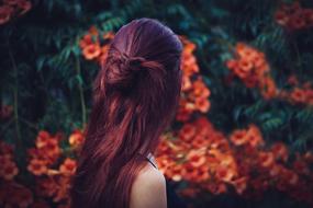 woman on a background of flowers, view from the back