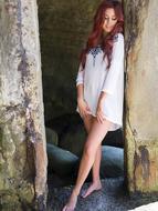 smiling Beautiful Red haired young girl standing barefeet