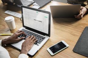 typing businessman on laptop