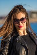 portrait of an attractive brunette in sunglasses