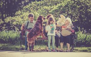 Family sitting on bench in park