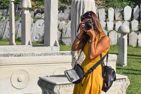 girl in a yellow dress takes pictures