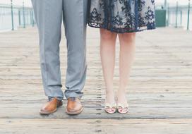 feet of man and woman on pier