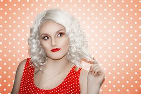 photo of a blonde in a red polka dot dress